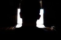 Man sitting in front of a laptop computer in the dark