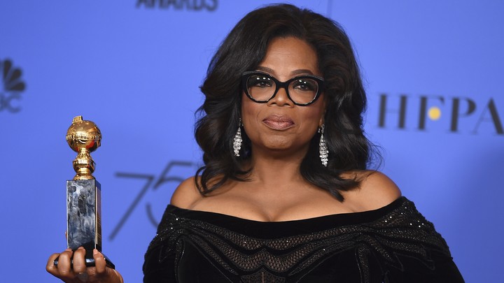 Oprah Winfrey stands with her Golden Globes award.