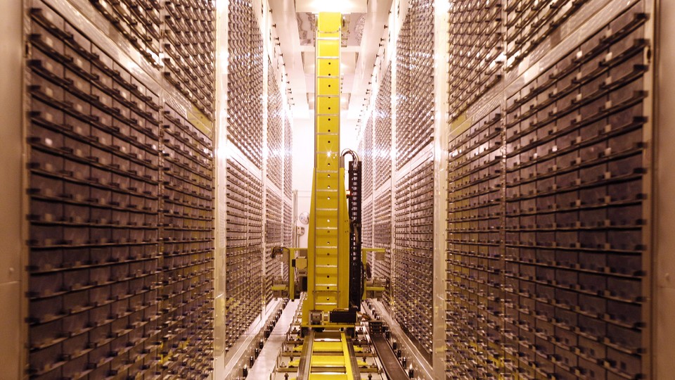 Yellow robot moving through storage freezer 