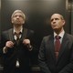 Two men riding in an elevator, staring somewhat skeptically at the ceiling, in "BlackBerry"