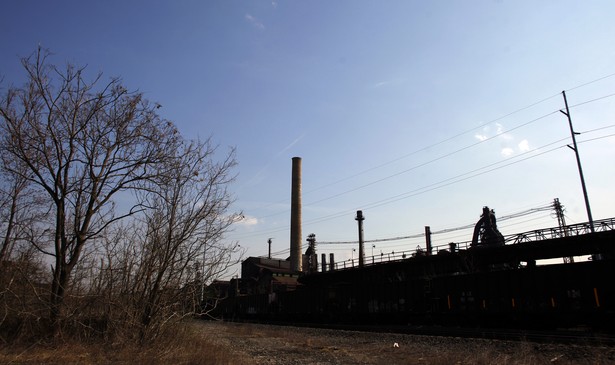 An abandoned-looking steel mill on a sunny day