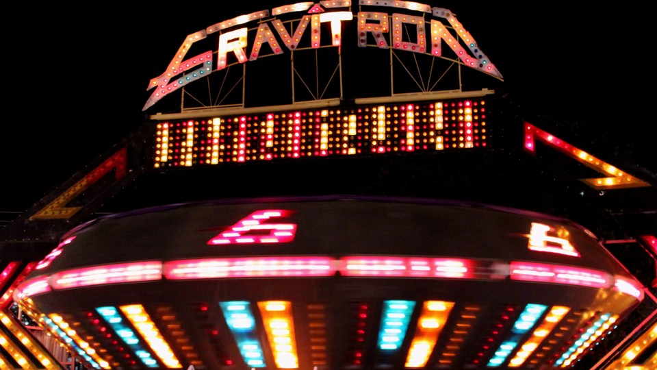 A gravitron ride at a carnival at night