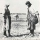 Two women standing with shovel
