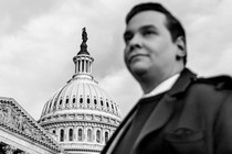 A photo of George Santos in front of the U.S. Capitol