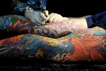 An image of tattooed legs