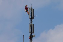 A worker atop a mobile-phone tower