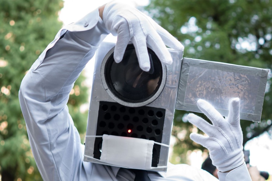 A person wears a costume shaped like a camera.