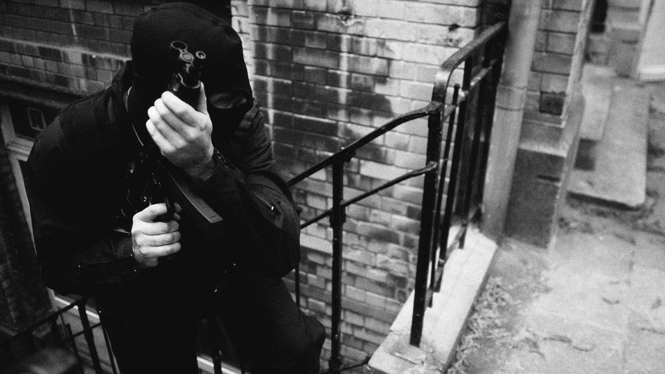 A masked man holding a gun