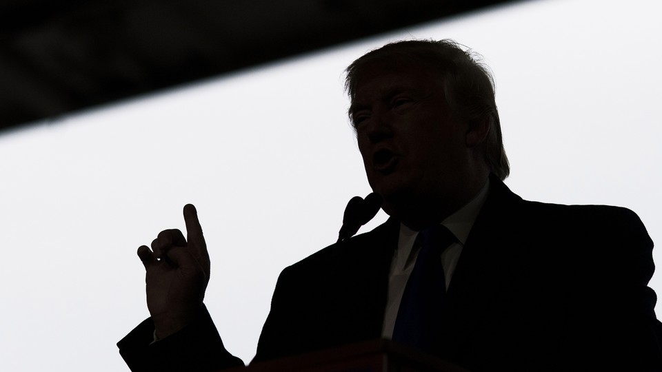A black-and-white photo of a silhouetted Donald Trump