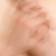 Blurry hands itching arm
