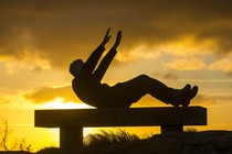 A man exercising on a bench