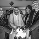 black-and-white photo of Egyptian president, king of Saudi Arabia, Melania Trump, and Donald Trump posing with hands on illuminated globe