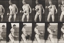 Still frames from black-and-white archival footage of two men, each lifting a barbell in their right hand