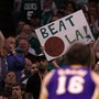 Fans of the Boston Celtics hold a 'Beat L.A.!' sign
