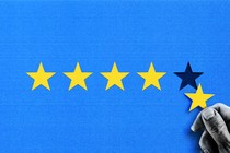 Image of five yellow stars on a blue background. A hand is taking away the fifth star.