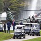 Donald Trump exits a military helicopter at his own golf resort