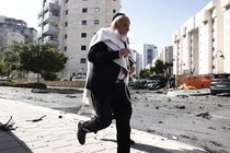 A man running from a rocket attack