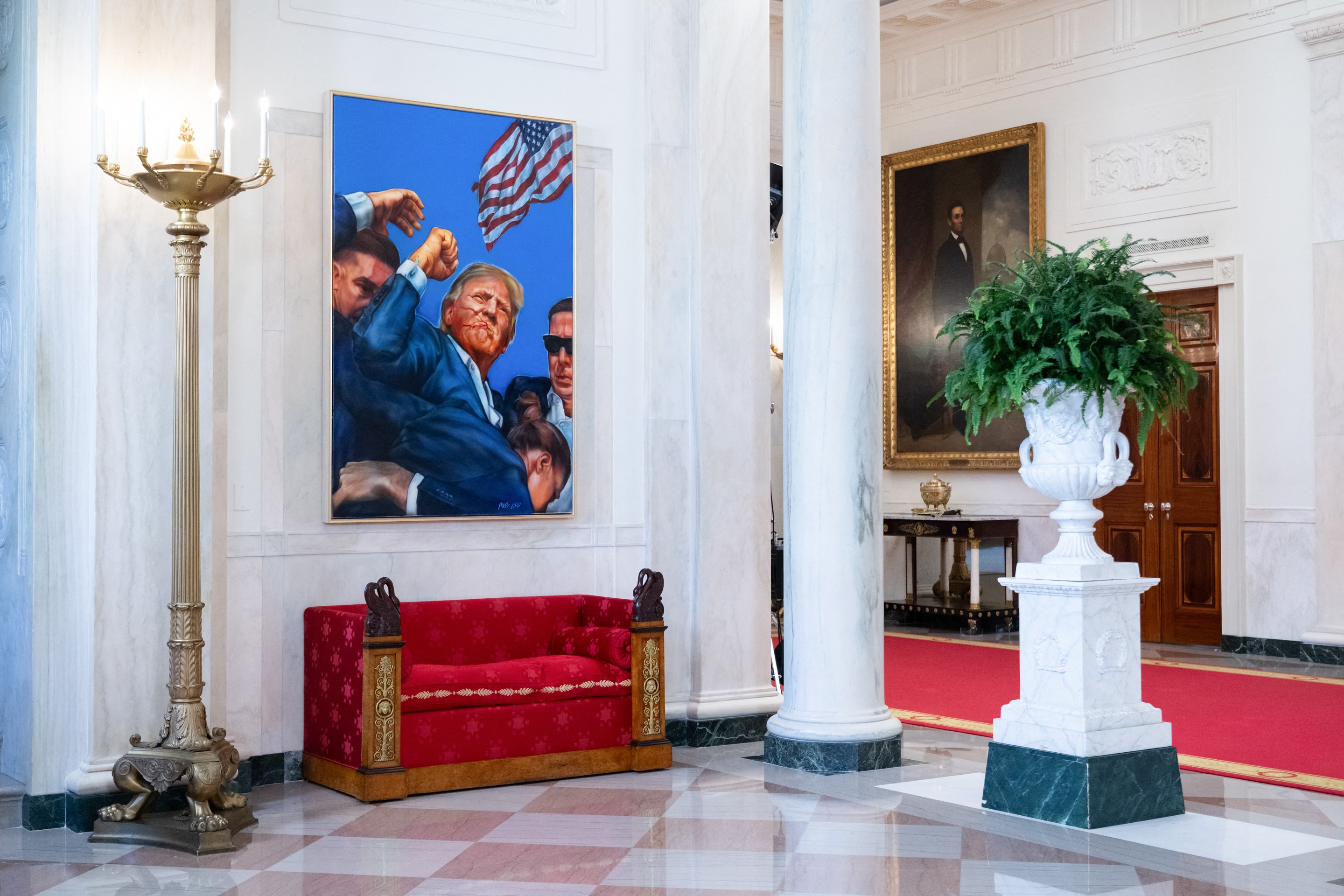 A painting of Donald Trump raising a fist hanging at the White House