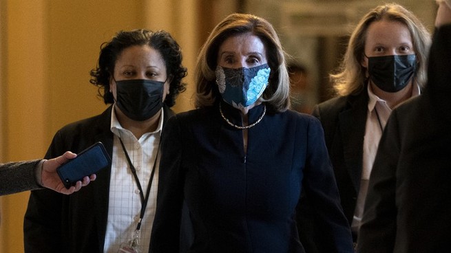 A photo of Nancy Pelosi wearing a mask