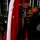 A waist-down view of a reveler wearing a red, white, and blue flag
