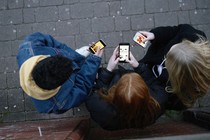 Three people looking at their phones