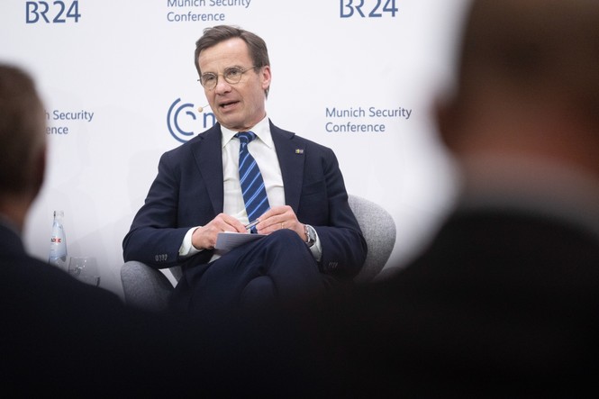 A man in a suit sitting in a chair