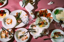 Dirty dishes on a pink table in a restaurant