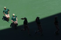 Five female tennis players are running.  