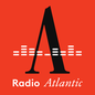 Photo of mirrored microphone against blue background, next to the "Radio Atlantic" logo
