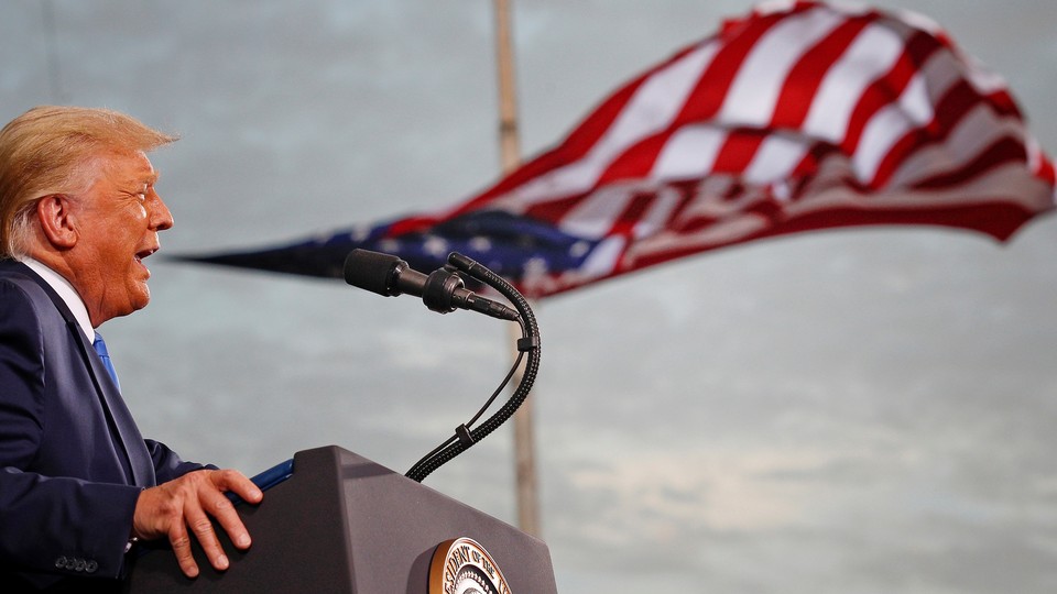 Donald Trump giving a speech where a flag in the background looks like it's coming out of his mouth