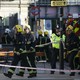 Members of the emergency services work outside Parsons Green underground tube station 