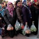 People wait in line to buy vegetables at a tent set up in Istanbul by the municipality.