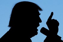 A silhouette of Donald Trump speaking into a microphone