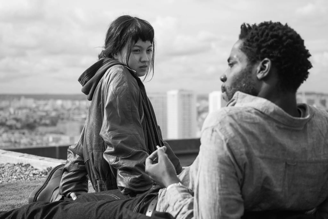 Two people lounging on a rooftop in "Paris, 13th District"