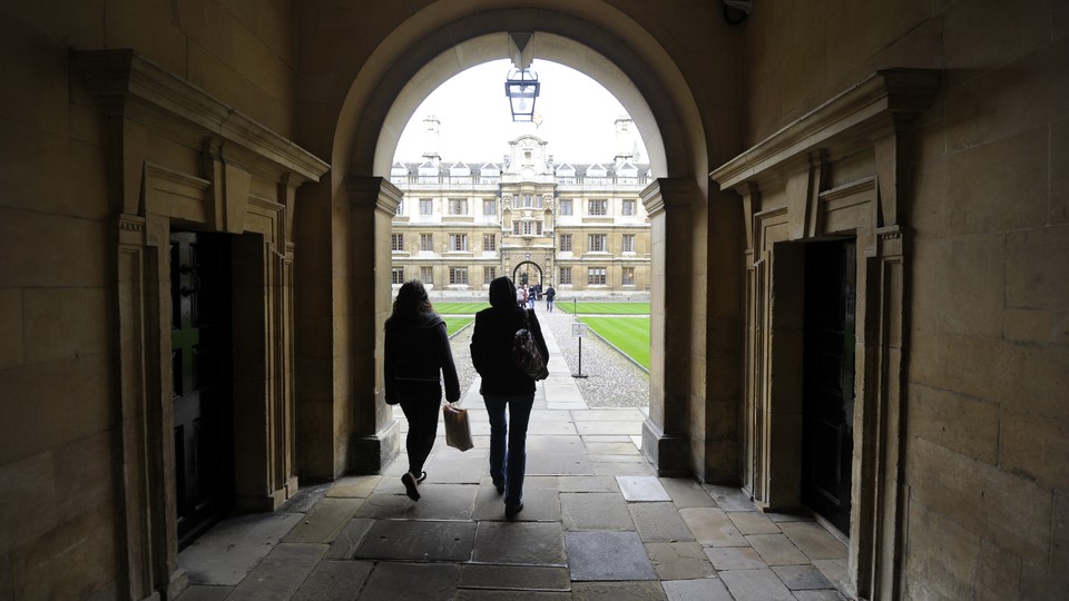 People walk into the quadrant of Clare College at Cambridge University in eastern England October 23, 2010.