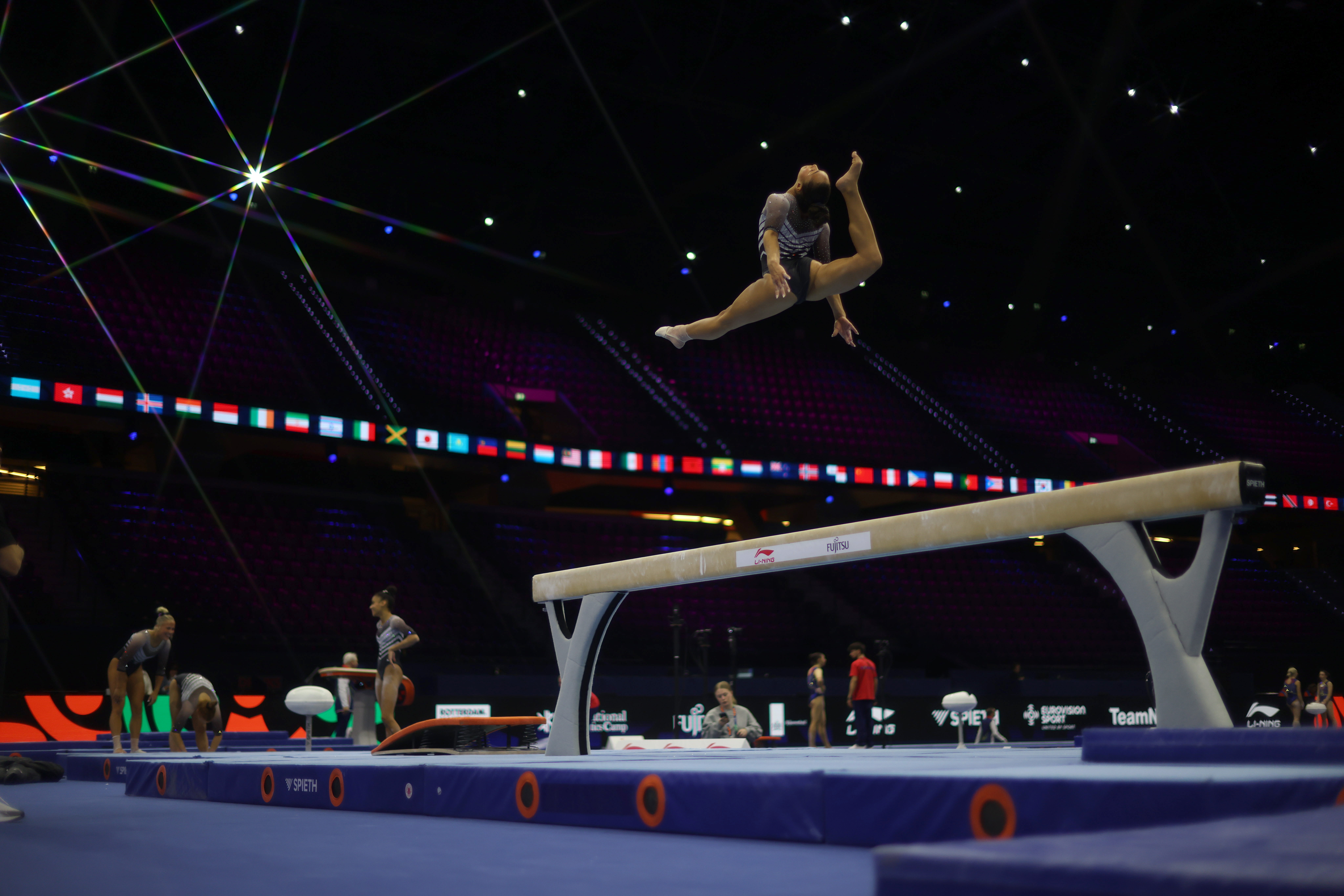 A gymnast practices their beam routine.