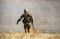 A photo of a soldier shown from the back