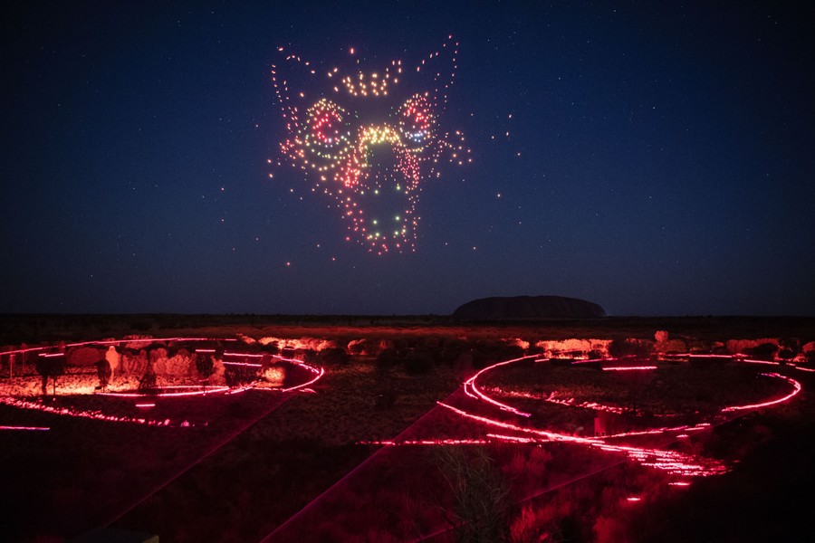 A drone-and-light show in the Australian wilderness. The drones form the shape of a frightening dog's head.