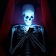 illustration of skeleton in coffin looking at smartphone