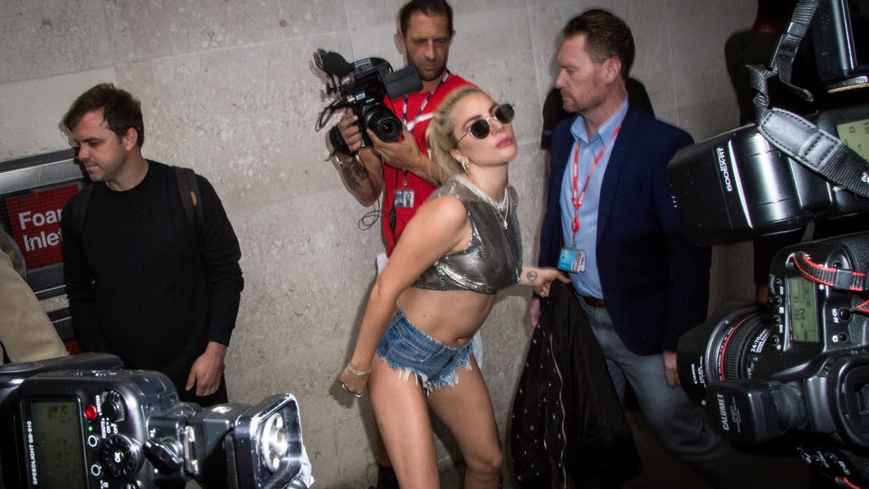 Lady Gaga poses for paparazzi.