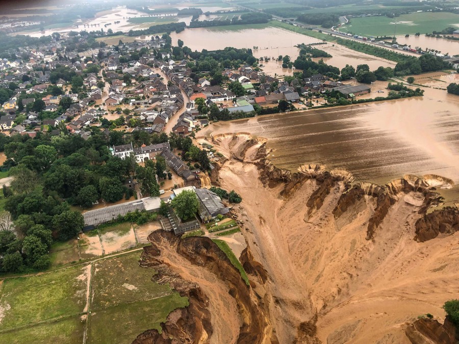 Flood damage seen from above, including a large washed-out field.