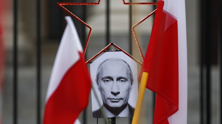 A photo of Russian President Vladimir Putin between two Polish flags