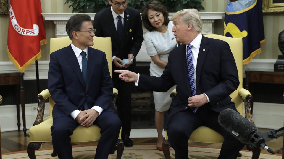 President Trump gestures his hand towards South Korean President Moon Jae-in