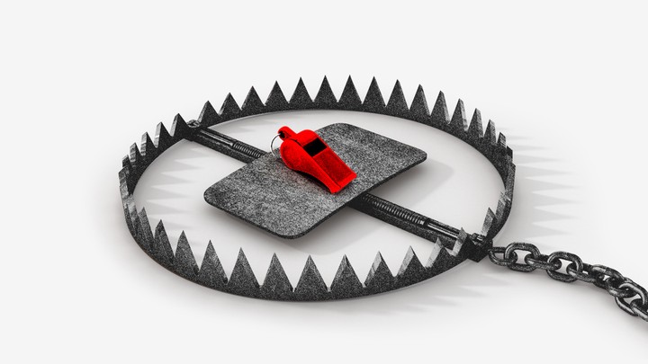 A red whistle sits inside an animal trap with sharp teeth