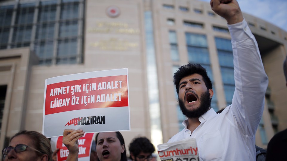 Journalists and activists gather outside an Istanbul court on July 28, 2017.