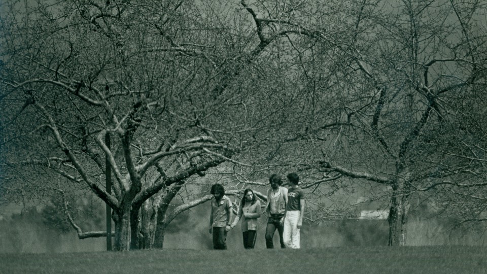 Students walking across Hampshire College's campus in 1977