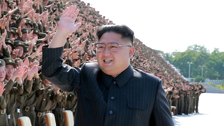 Kim Jong Un waves and smiles