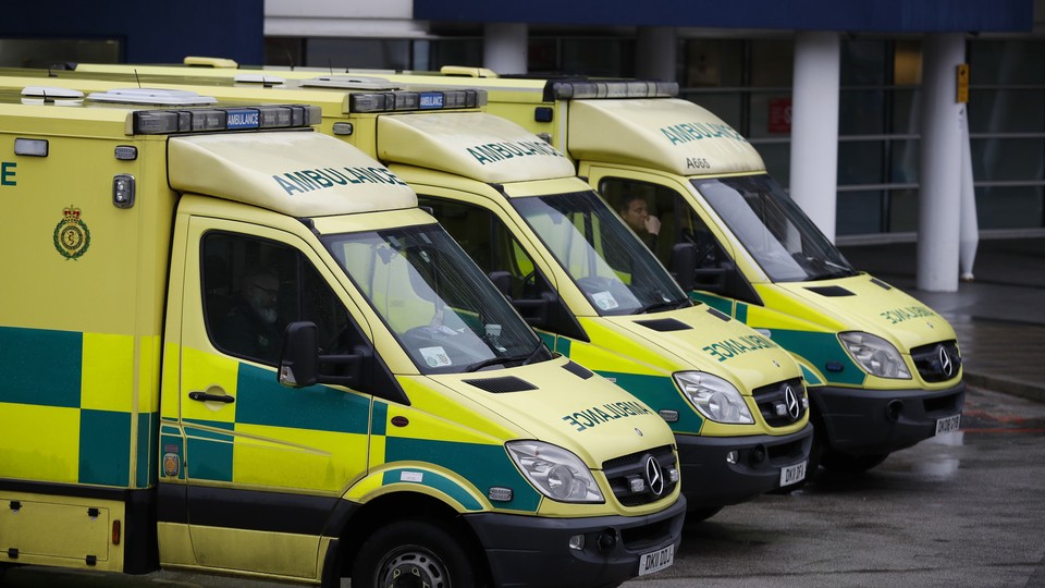 Ambulances wait outside the emergency department at the Royal University Hospital in Liverpool, England, in January 2017.