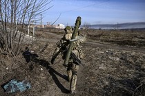 Ukrainian serviceman walking away from the camera