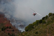 A Cal Fire helicopter flies over Garrapata State Park